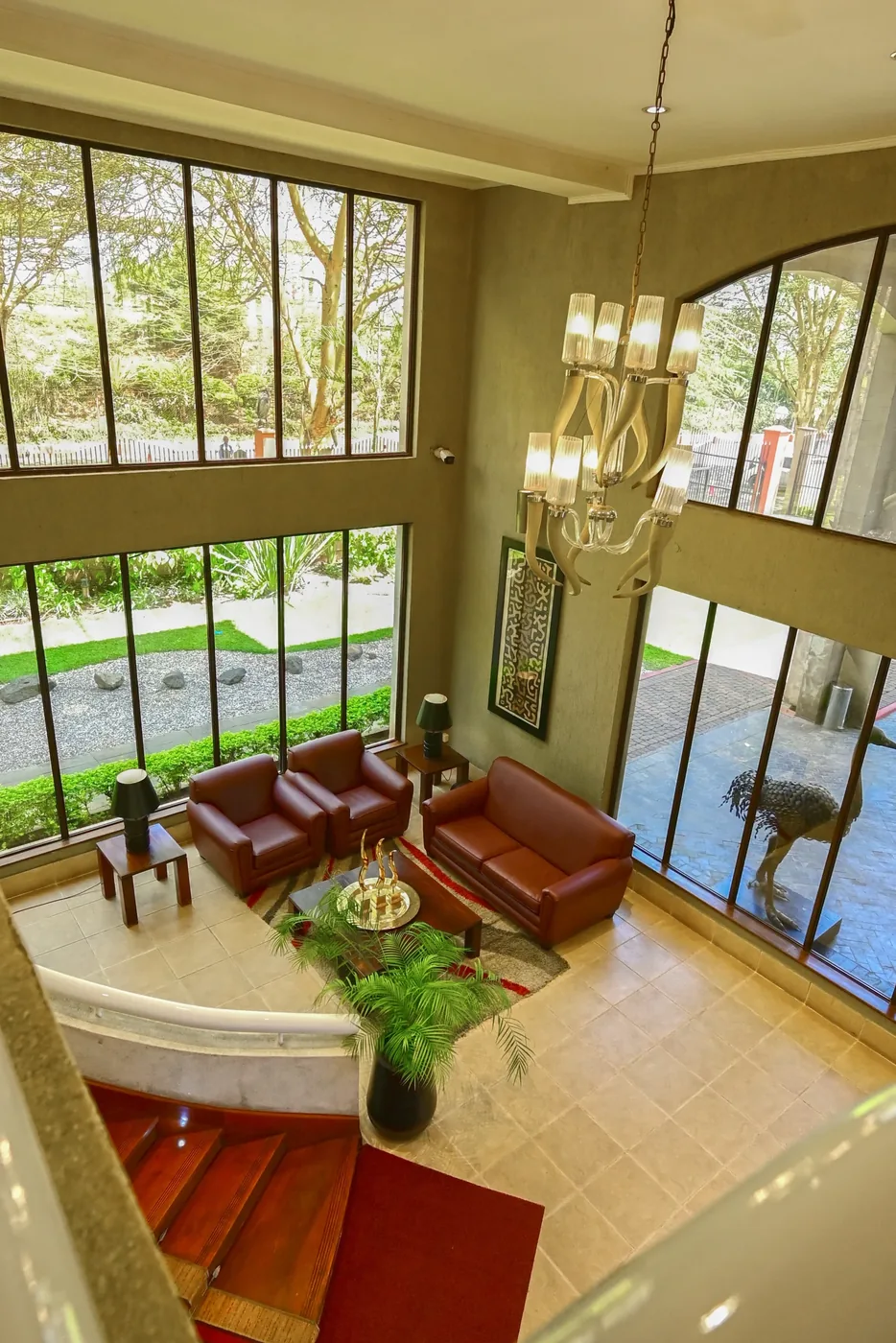 A seating area overlooking Ole Sereni's double-height lobby, lit by a chandelier